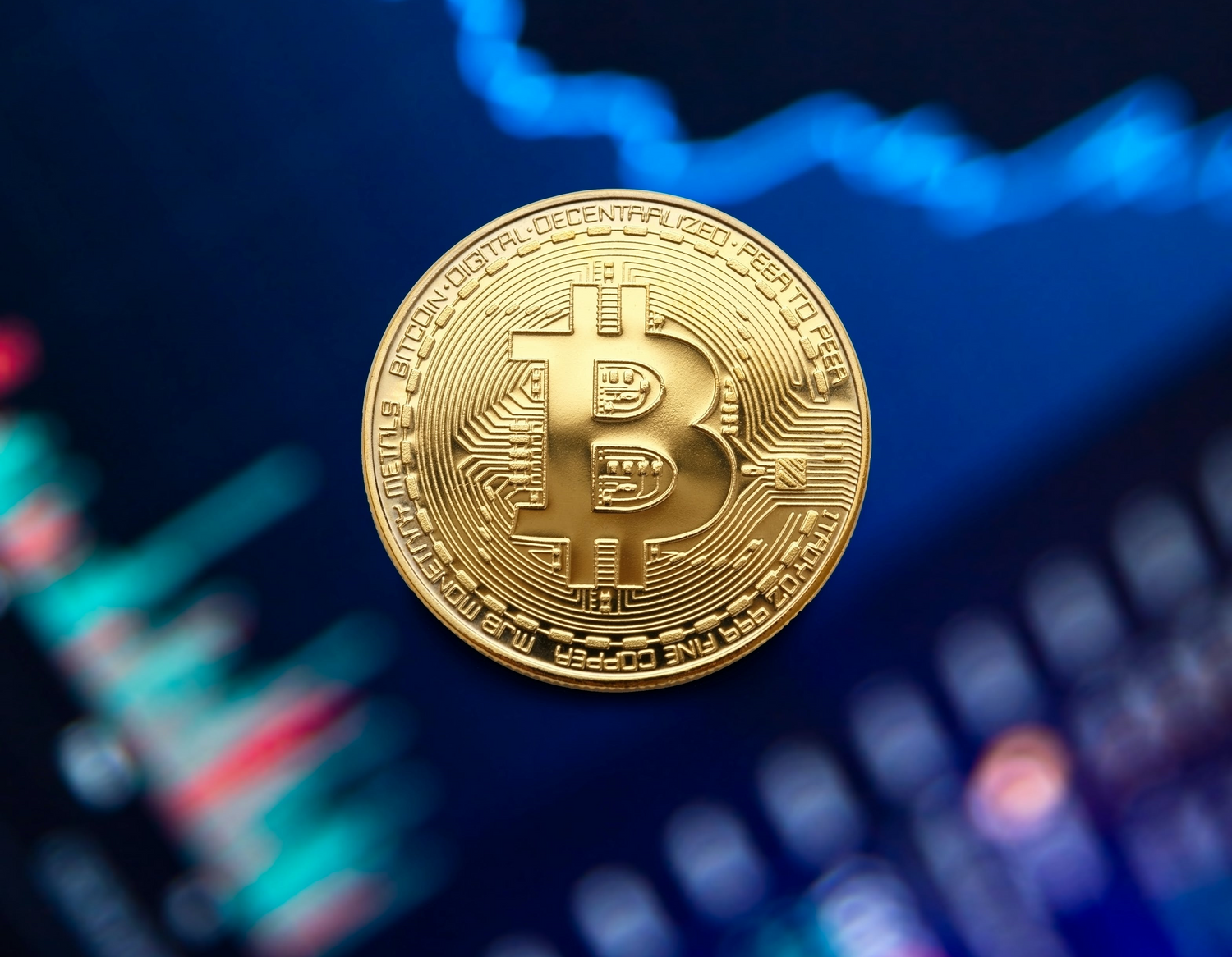 Gold coin placed in front of spreadsheet with graphs.
